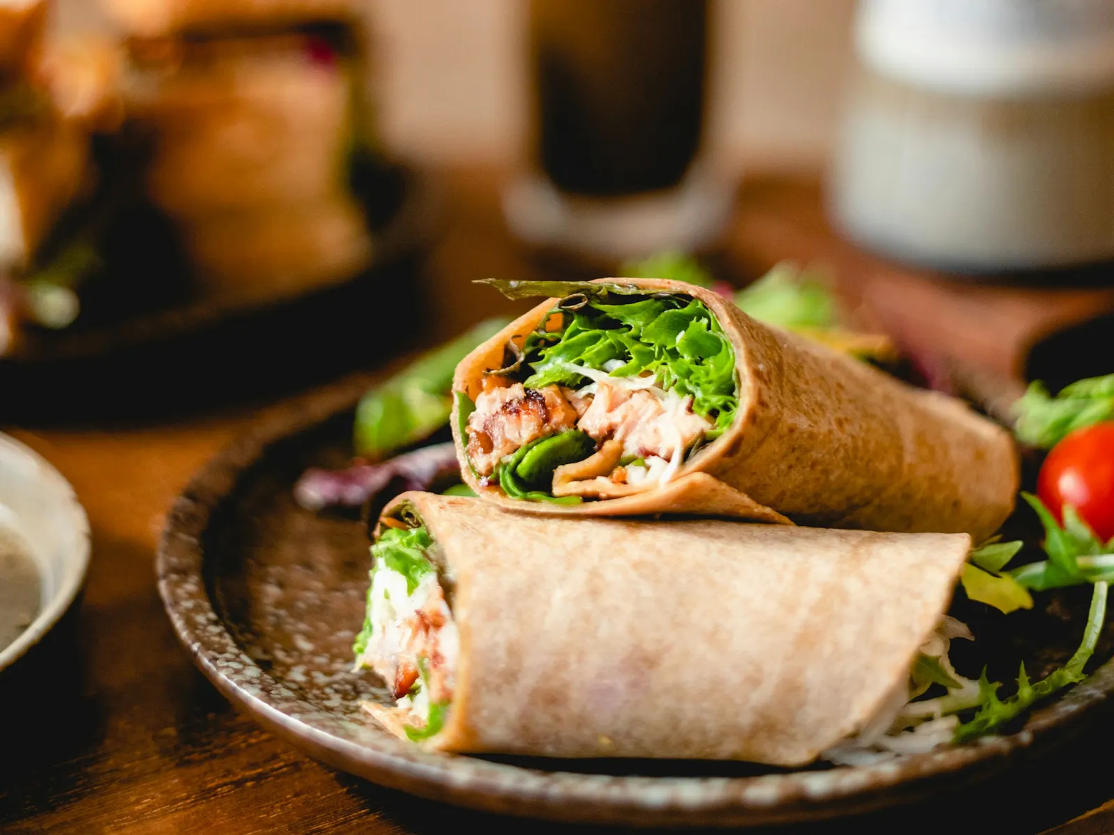 Filled wrap on a plate with salad
