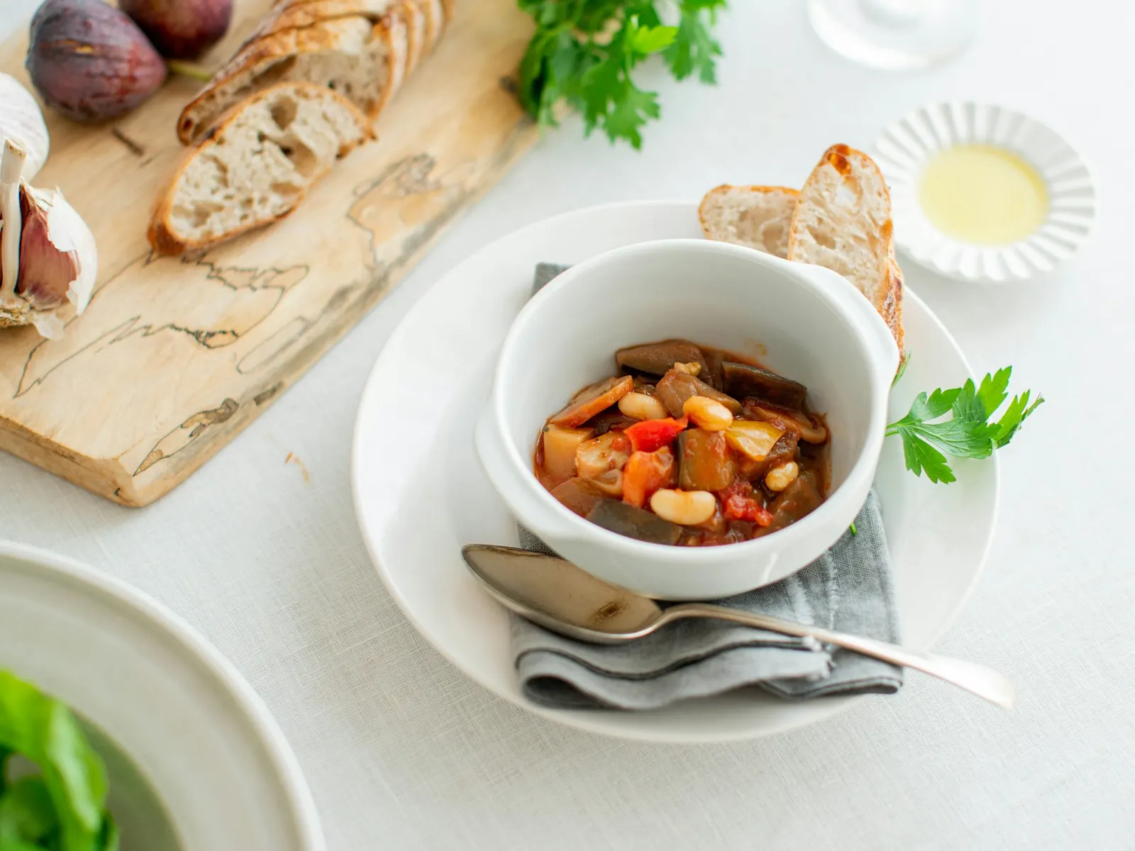 Bowl of chicken soup with bread and a spoon